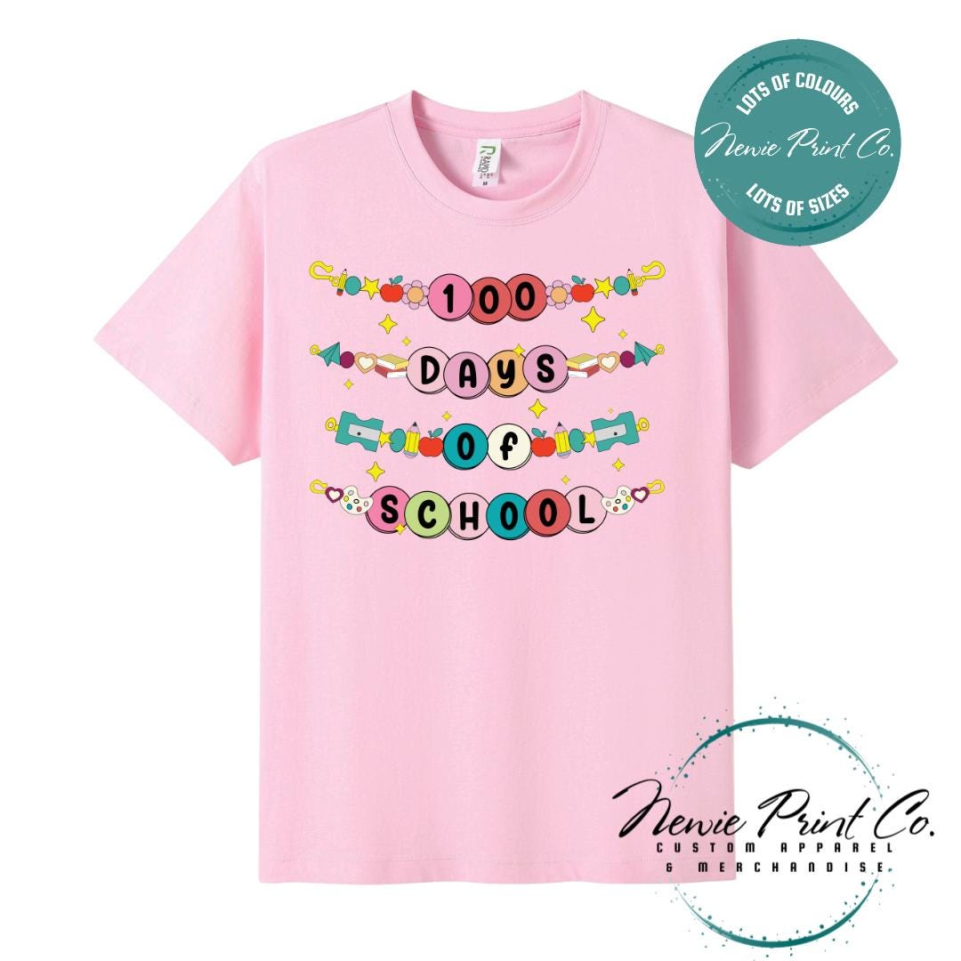 Pink 100 Days of School t-shirt featuring a colourful friendship bracelet with the text “100 Days of School,” designed for students or teachers to celebrate the 100th day of school milestone in a fun, playful way. Available in both adult and kids sizes.